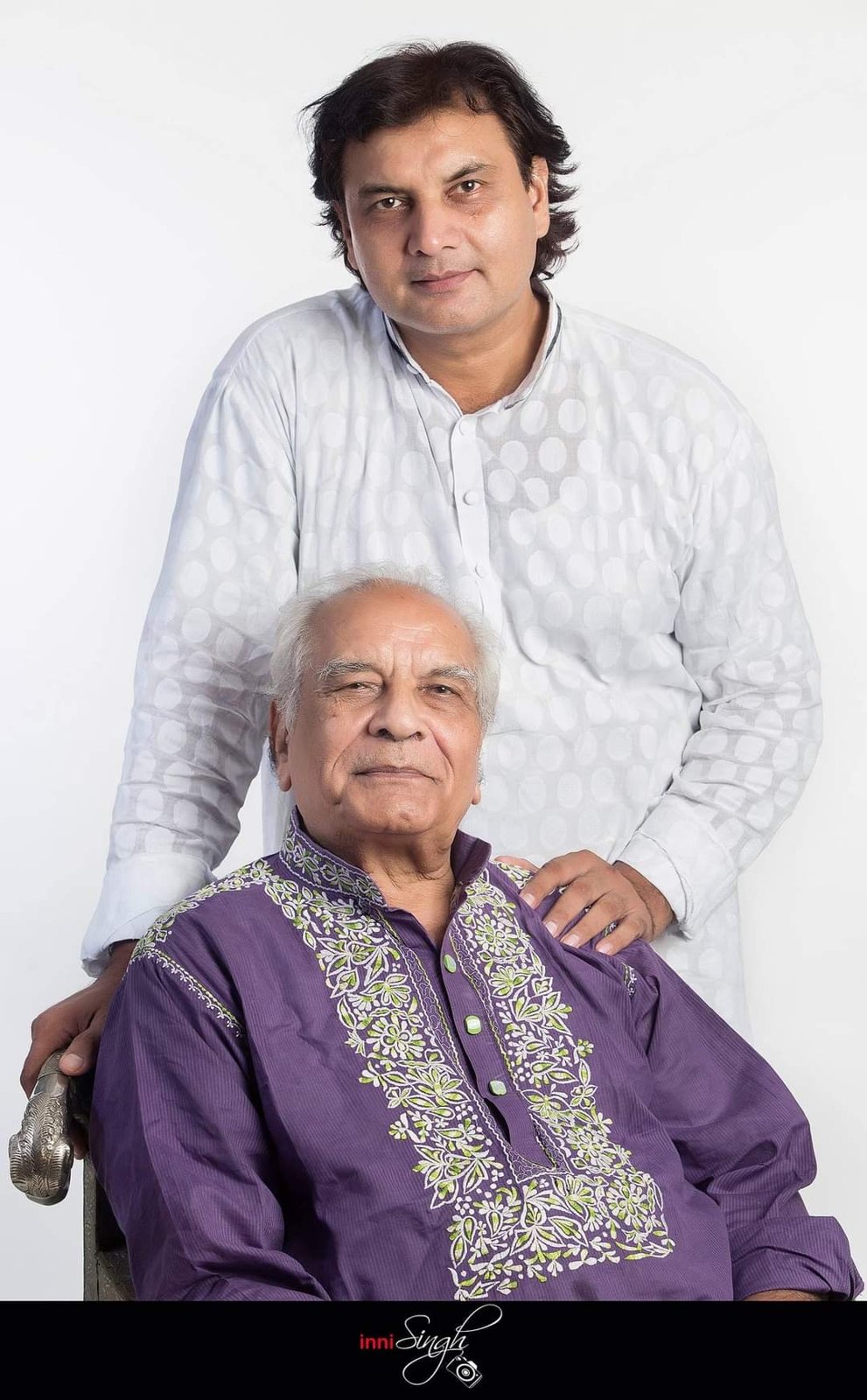 Ustad Akram Khan standing behind his seated father Ustad Hashmat Ali Khan
