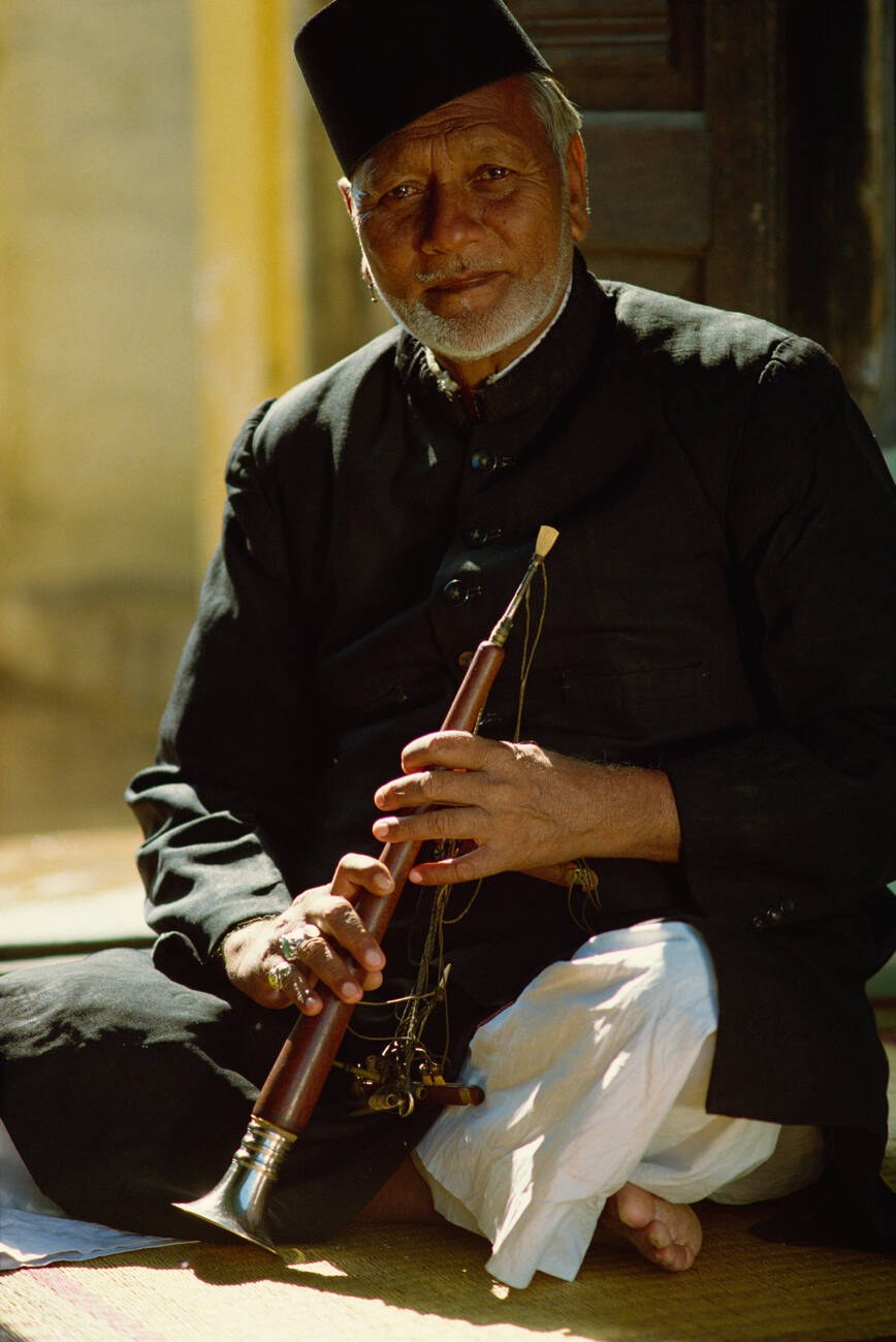 Portrait of Bismillah Khan wearing a white cap, facing the camera.