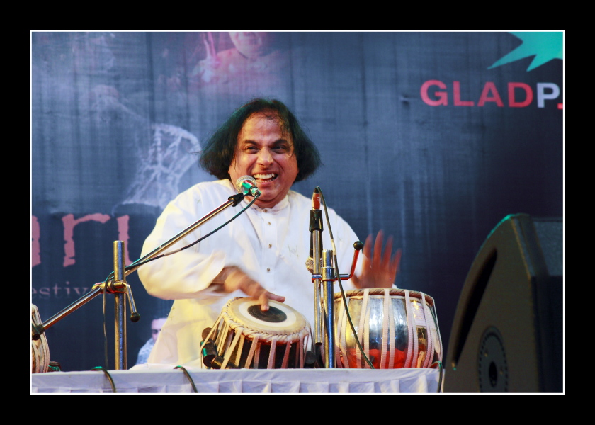Pandit Suresh Talwalkar playing the tabla on stage during a 2011 concert.